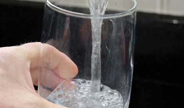 Hand filling up glass