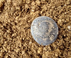 An image of a Roman coin found by Wessex Archaeology - working with Southern Water carrying out archaeological investigations along the route of a new proposed pipeline in Hampshire
