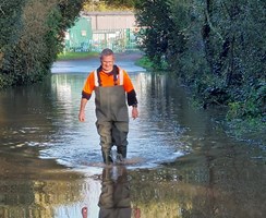 Man walking in flooded surface water